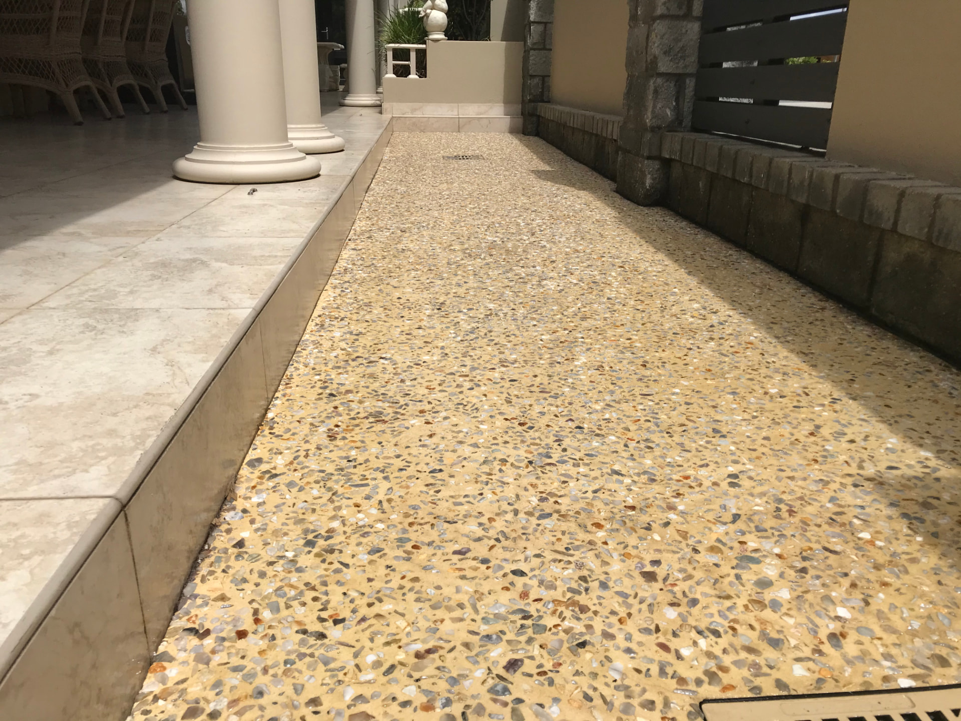 The same exposed aggregate path after cleaning and sealing, with brightened colour and a clean satin finish