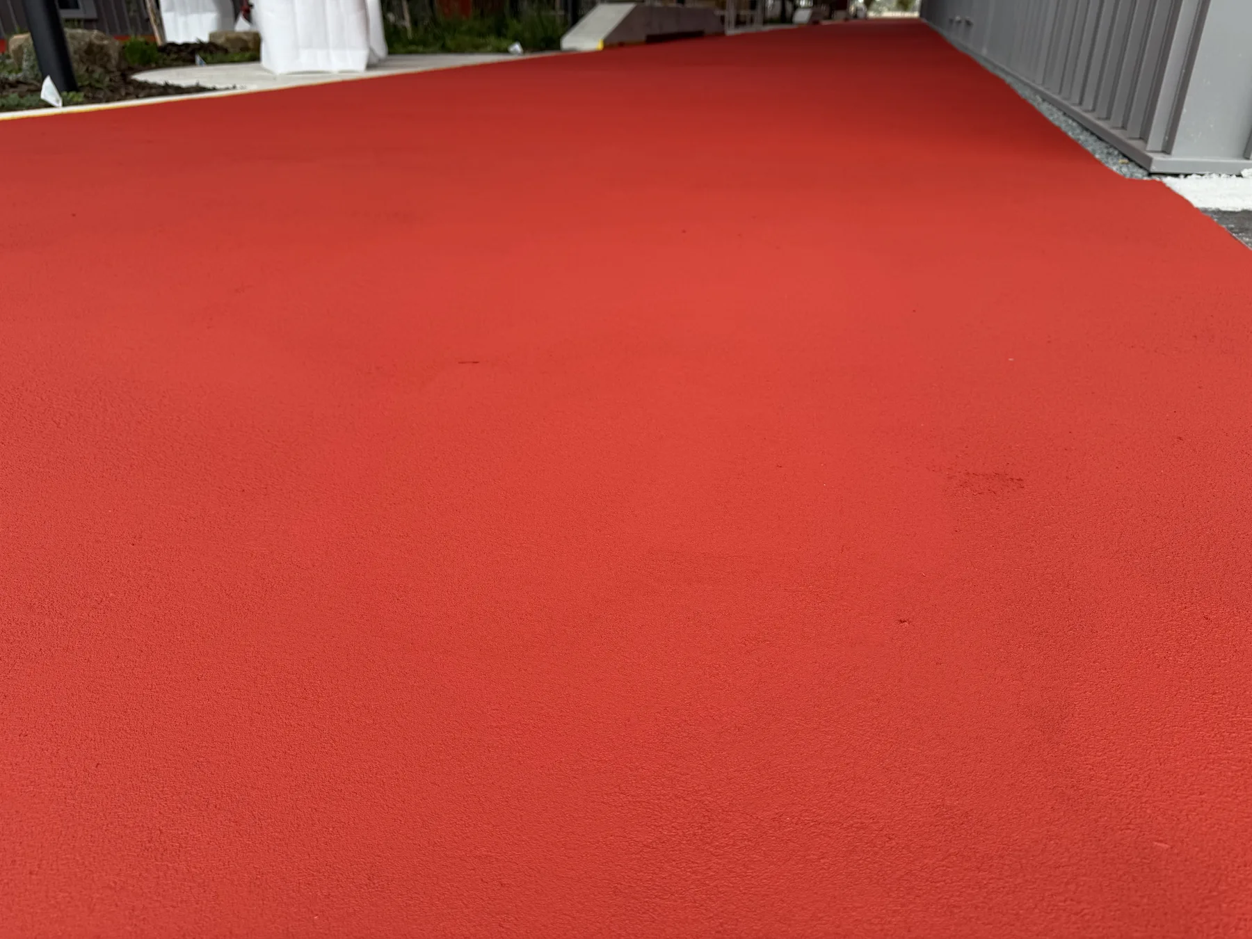 Close view of the finished red StreetBond coating showing its fine textured, colour-stable surface