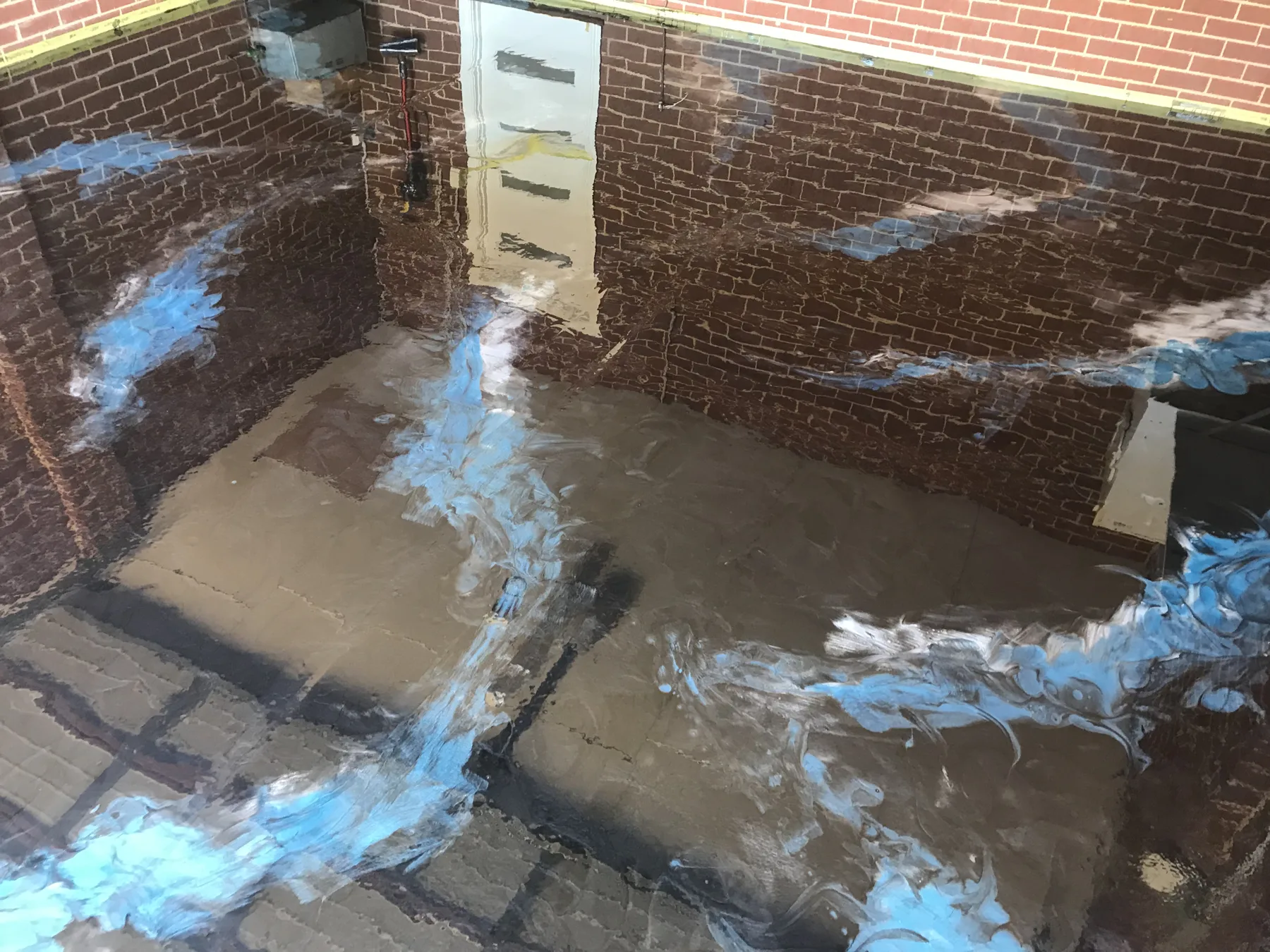 Blue metallic epoxy floor with soft cloud-like pigment movement and a high-gloss topcoat